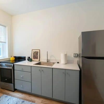 A Kitchen With A Sink And A Refrigerator