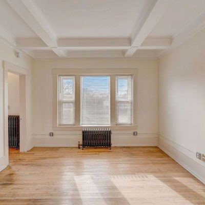 A View Of A Hard Wood Floor Next To A Window