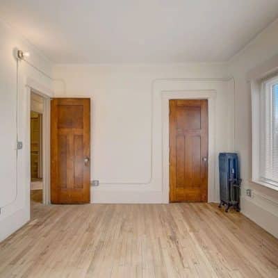 A Close Up Of A Hard Wood Floor Next To A Window