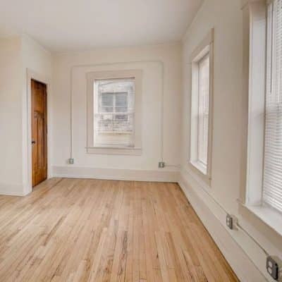 A Close Up Of A Hard Wood Floor Next To A Window