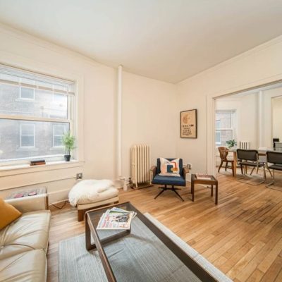 A View Of A Living Room With A Wood Floor