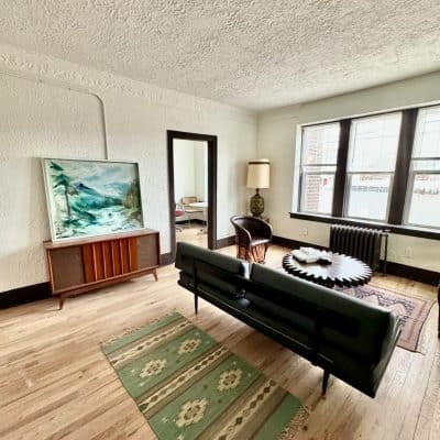 A View Of A Living Room With A Wooden Floor