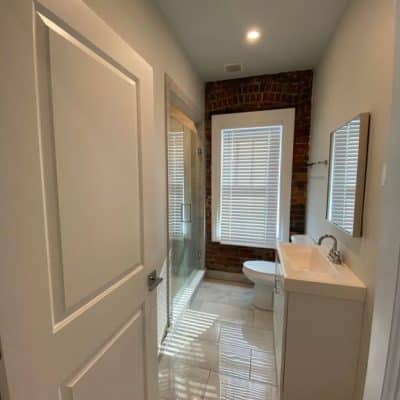 A Room With A Sink And A Mirror