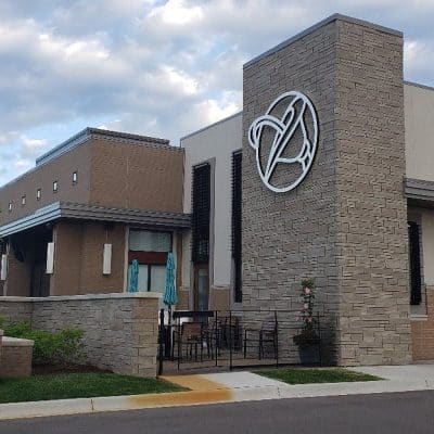 A Statue In Front Of A Brick Building