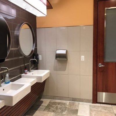 A Restroom With A Sink And A Mirror