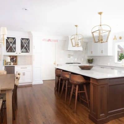 A Kitchen With Wooden Cabinets And A Dining Room Table