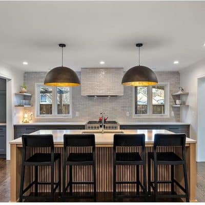A Kitchen With An Island In The Middle Of A Room