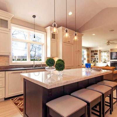 A Modern Kitchen With An Island In The Middle Of A Room