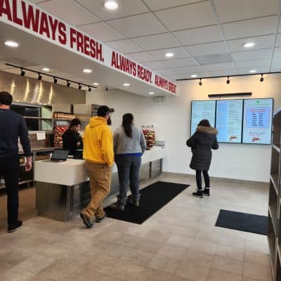 A Group Of People Standing In A Room